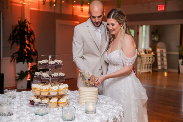 Couple cutting their wedding cake during an elegant reception at The Grandview Venue