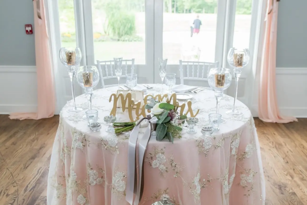 Intimate head table styled for a micro wedding at The Oaks Grandview Venue, featuring elegant place settings, soft florals, and a personalized “Mr & Mrs” sign.