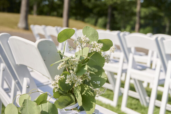 Ceremony seating decorated with greenery for an outdoor wedding at The Grandview at The Oaks