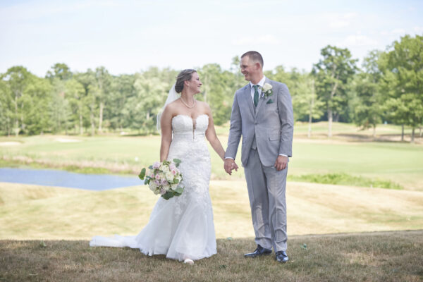 Couple posing on the ceremony lawn at The Grandview Venue at The Oaks
