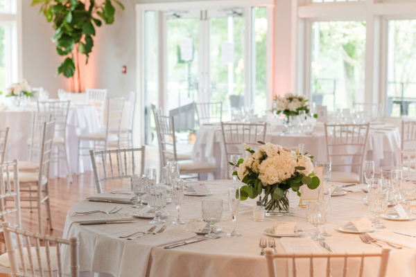 Table setting with white florals at the reception venue at The Oaks Grandview Venue