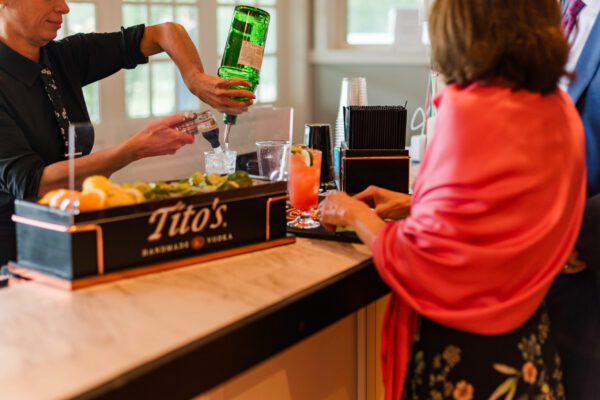 Bartender pouring a drink for a wedding guest at a wedding reception at The Grandview